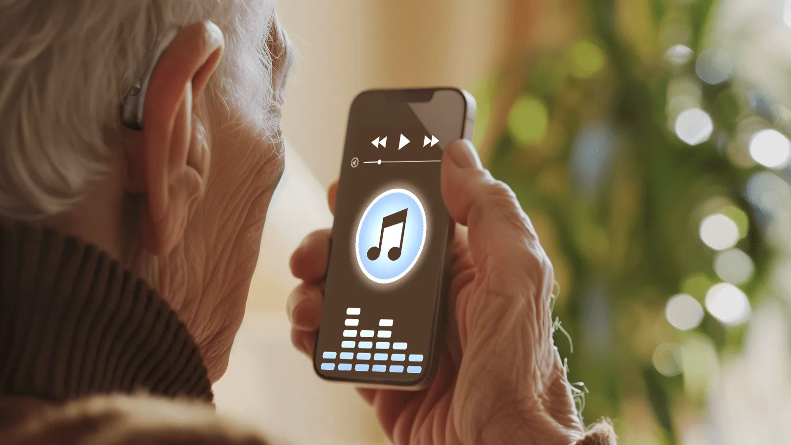 An elderly person wearing a Beacon Hearing aid is listening to music through its Bluetooth