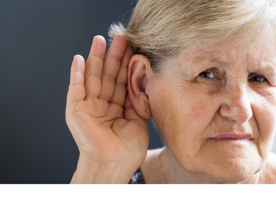 Senior woman cupping ear