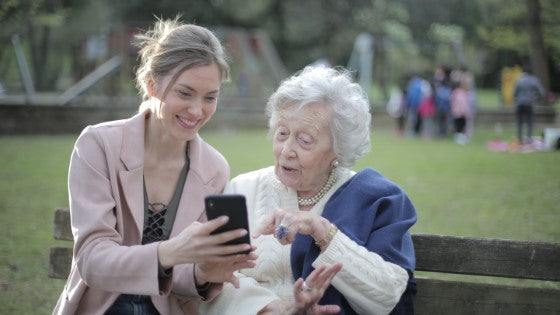 Senior mom and daughter on a park bench