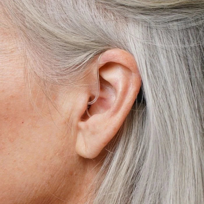 Ceretone Nexus over the counter hearing aid on the ear look. Discreet size and look, behind the ear hearing aid.