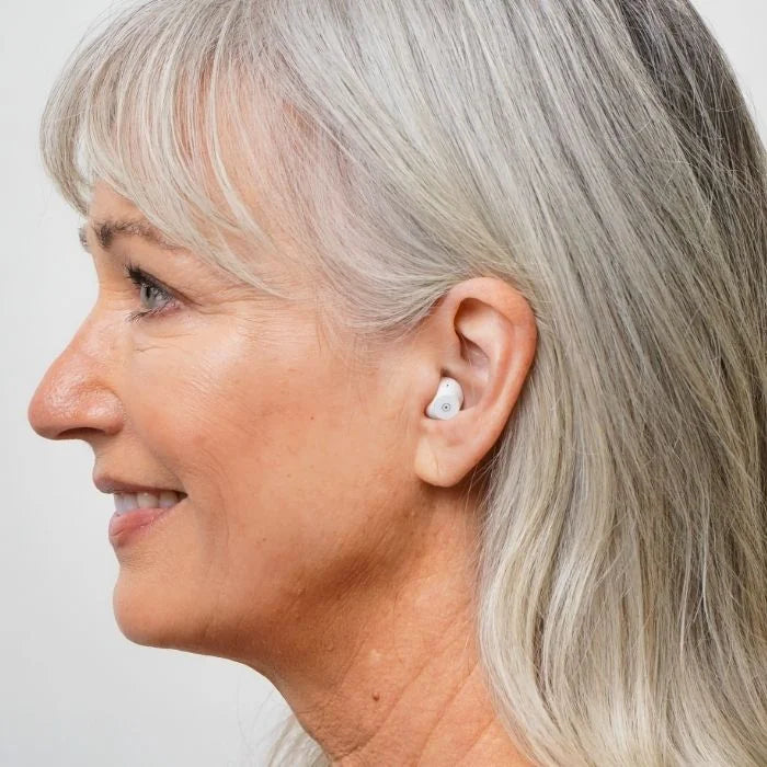 Side profile view of Fusion OTC hearing aids on the ear. Showcasing the small size and discreet design of the hearing aid