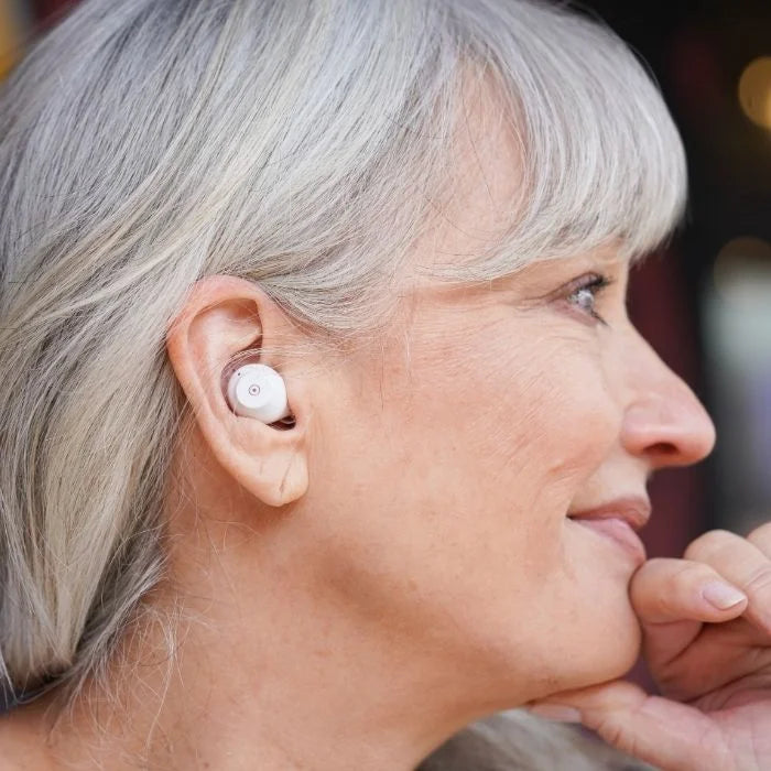 Discreet look of fusion over the counter hearing aids in an outdoor setting. Easy to use with one button.